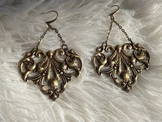 Antique brass art nouveau scroll work earrings. French ear wire is also brass. They are 3.5 inches long with chain. If you need them shorter please include instructions when you purchase so that I can adjust them Art Nouveau Earrings, Work Earrings, Art Nouveau Earring, Art Nouveau Antiques, Urn Pendant, Brass Art, Scroll Work, Ear Wire, Stones And Crystals