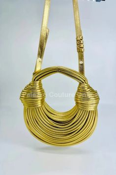 Elevate your accessory game with the luxurious "Gold Serpentine Rope Hobo #Handbag." This stunning handbag is crafted with intricate rope detailing that creates a serpentine effect, exuding #elegance and sophistication. The shimmering gold finish adds a touch of #glamour, making it the perfect statement piece for any outfit. Ideal for both day and night, this versatile hobo handbag is spacious enough to carry all your essentials while maintaining a chic and stylish look. Pair it with your favorite dress or casual ensemble to shine at every occasion. Belt Ring, Casual Beach Wear, Gold Palette, Screen Color, Hobo Handbag, Gold Handbags, Photography Lighting, Hobo Handbags, Color Calibration