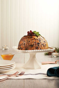 A British-style Christmas pudding on a white cake stand. Cranberry Pudding, Steamed Pudding, Spiced Applesauce, Christmas Pudding Recipes, Roast Beef Dinner, Caramel Ingredients, Pudding Mold, Caramel Topping, Pudding Cake