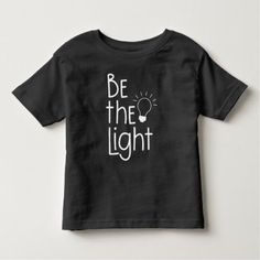 Christian Be The Light Funny Inspirational Toddler T-shirt Basic Black Ring-spun Cotton Top, Black Basic Ring-spun Cotton Top, Pre-shrunk Black Ring-spun Cotton Shirt, Black Pre-shrunk Ring-spun Cotton Shirt, Black Short Sleeve T-shirt In Ring-spun Cotton, Unisex Black T-shirt In Ring-spun Cotton, Black T-shirt With Text Print, Unisex Black Ring-spun Cotton T-shirt, Black Ring-spun Cotton T-shirt With Text Print