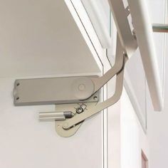 a pair of scissors hanging from the side of a door with an extension to it