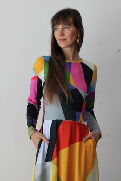 CITRINE DRESS  The original abstract print design on the dress is created by a professional artist. Colourful abstract print dress with geometrical elements, with long sleeves. Be unique. Be outstanding. Be authentic. Bright and lively colors have the power to uplift mood and instill a sense of joy. Wearing a vibrant color dress can evoke feelings of happiness and positivity, brightening not only the wearer's day but also those around her. The dress showcases an original abstract print design, where dynamic geometrical elements dance across the fabric in a symphony of colors. Bold triangles, squares, and circles intertwine, creating a visual feast for the eyes. Each element is meticulously placed to evoke a sense of movement and rhythm.  * 95% polyester, 5% elastane (fabric composition may Chic Multicolor A-line Midi Dress, Multicolor Abstract Print Midi Dress, Multicolor Bold Print Midi Dress, Chic Multicolor Abstract Print Maxi Dress, Chic Abstract Print Maxi Dress, Multicolor A-line Mod Dress, Multicolor Mod A-line Dress, Multicolor Long Sleeve Dress With Geometric Pattern, Long Sleeve Multicolor Dress With Geometric Pattern