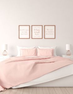 a bed with pink sheets and pillows in a white room next to two pictures on the wall