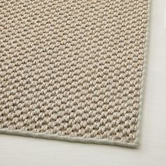 a close up view of a rug on a white table with a light colored background