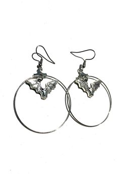 Shiny silver vampire bat earring hoops, perfectly spooky or something special for Halloween 🎃  Hoops measure approximately 40mm wide and the dainty bat charm hangs in the top centre. Made with stainless steel French hook style earrings Comes with a organza drawstring gift pouch to keep your earrings safe or give as a gift. Follow @helloween_13 on Instagram Edgy Sterling Silver Jewelry For Halloween, Silver Punk Hoop Earrings For Party, Edgy Halloween Jewelry, Edgy Pierced Halloween Earrings, Edgy Dangle Earrings For Halloween, Edgy Halloween Pierced Earrings, Edgy Pierced Earrings For Halloween, Edgy Adjustable Earrings For Halloween, Spooky Silver Pierced Earrings