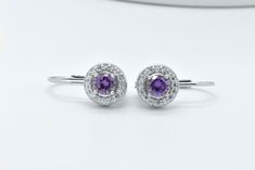 Here we beautiful and uniquely designed classic Style simulated Amethyst earrings. The earrings feature round cut purple simulated amethyst gemstones with simulated white diamonds. The total carat weight is approx. 0.50ct. These gemstones are one of the finest simulated gemstones in the market. These gemstones are cut just like mined gemstones. Stock# VJSDNAR9SEC-4989-AM-E * Made from 925 sterling silver * Simulated amethyst * Elegant French Hoop Wire Design * LeverBack fastening Formal Round Gemstone Hoop Earrings, Classic Round Amethyst Earrings, Formal Purple Round Earrings, Sterling Silver Halo Round Earrings, Round Sterling Silver Halo Earrings, White Gold Amethyst Earrings Fine Jewelry, Formal Silver Gemstone Hoop Earrings, Elegant Purple Gemstone Hoop Earrings, Lavender Amethyst Round Earrings