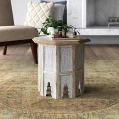 a living room with a couch, chair and potted plant on the end table