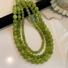 This exquisite necklace features natural green quartz beads paired with luxurious 24K gold-plated copper, making it a perfect blend of elegance and timeless charm. The earthy green hues of the quartz provide a refreshing, vibrant touch to your outfit, while the adjustable length allows for versatile styling. Whether worn for casual occasions or formal events, this piece elevates any look with its subtle yet captivating design. Details Material: Natural green quartz with 24K gold-plated copper Bead sizes: 6mm, 8mm, 10mm Total length: 46cm (including a 5.5cm adjustable chain) Weight: Available in 24g, 39g, and 60.42g options Missy Jewelry Natural Stone Necklace Collection Earthy Green Jewelry With 8mm Beads, Earthy Green Gemstone Necklace, Earthy Agate Beaded Necklace, Bohemian Green Agate Beaded Necklace, Green Agate Necklaces With Polished Beads, Natural Stone Necklace, Earthy Green, Bead Sizes, Necklace Collection