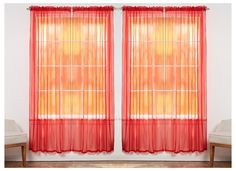 two red curtains hanging on the side of a wall