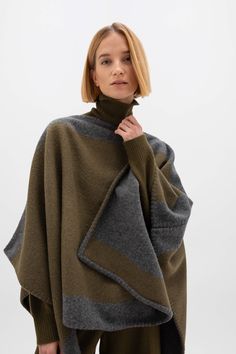 A new poncho shape for us with longer sides. Woven in our own mill and finished at Makers Croft, our onsite sewing atelier. We create our signature blanket stitch detail using vintage Singer sewing machines. Styled with our Gauzy Cashmere Roll Neck and Slouchy Cashmere Trousers in olive. Leather Poncho, Sewing Atelier, Cashmere Trousers, Poncho Fashion, Singer Sewing Machines, Tartan Accessories, Vintage Singer, Cashmere Socks, Autumn Wardrobe