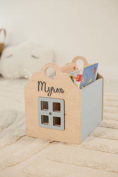 a wooden toy house with the name morgan on it's front and door open