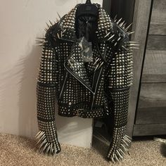 This Jacket Has Huge Spikes And Studs All Over It. It’s A Size Small, And It’s Brand New With Tags Still Attached. I Paid $600 For It. Reasonable Offers Only, Item Weighs 12lbs. Extra Spikes And Studs Are Included In Case You Lose One. Real Leather And Stainless Steel Studs And Spikes. This Coat Is Brand New And Hasn’t Even Been Worn. There Are No Flaws, Rips Or Anything. This Is New. Sleeves Do Have Zippers This Item Fits A Size 2-4 Measurements: Shoulders: 15.5” Chest: 35” Waist: 30” Hips: 36” Studded Outerwear For Streetwear, Party Outerwear With Studs And Long Sleeves, Studded Winter Party Outerwear, Studded Leather Jacket For Party, Studded Winter Outerwear For Party, Party Outerwear With Rivets, Studded Party Outerwear, Designer Winter Outerwear With Rivets, Fitted Studded Outerwear For Party