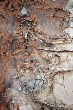 an abstract painting with brown and white paint