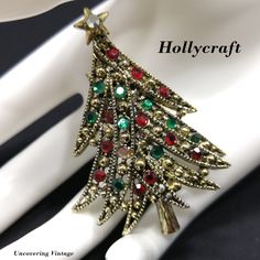 *Description: This is a beautiful Hollycraft "Ribbon Tree" brooch from the 1950s. This brooch is featured in Mary Morrison's Christmas Jewelry book on page 43. She explains the brooch is sometimes called the ribbon tree for its many layers of long, curved, ribbon-like branches, each adorned with alternating stones and knobs. The Hollycraft stamp on the back with a copyright in front dates this piece at 1955 or after. There is one missing flat back red rhinestone which could easily be replaced if Jewelry Book, Ribbon Tree, Christmas Bling, Tacky Christmas, Christmas Pins, Red Rhinestone, Christmas Jewelry, Christmas Decorating, Beautiful Packaging