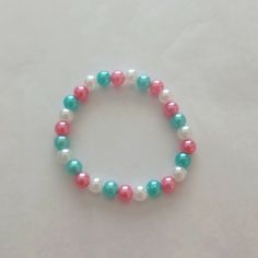 a beaded bracelet with red, white and blue beads on it's end