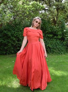 A beautiful vintage evening dress, dating from the late 1940s. Petal shaped cuffs, waistline and collar. Made from synthetic grosgrain textured satin. The fabric is a slightly muted reddish pink. Fastens with a long row of buttons and loops to the back. The dress is still very strong, but is showing some signs of age. There is some discolouration to the buttons and some faint marks under the arms, and scattering of other other small marks on the bodice. Nothing huge, just small age spots.  Chest Elegant Fitted Vintage Dress In Solid Color, Elegant Solid Color Fitted Vintage Dress, Fitted Solid Color Maxi Dress With Pleated Bodice, Fitted Solid Maxi Dress With Pleated Bodice, Classic Vintage Evening Dress For Summer, Red Fitted Tea-length Dress, Classic Vintage Dress With Fitted Bodice For Evening, Vintage A-line Maxi Dress For Evening, Classic Vintage Midi Length Dress For Evening