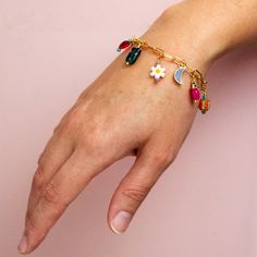 We love this bracelet! The multi-colored loveliness of the Lorelei Charm Bracelet is packed full of unique beauty and is sure to bring a fresh new feel into your jewelry collection. This paperclip chain bracelet includes an assortment of colorful charms. You can wear this bracelet solo on your wrist or stack it with other bracelets to create a look all your own. Single strand Approximately 8 inches long Gold plated over brass chain and clasp Lobster clasp Adjustable Nickel and lead free Beads in Trendy Multicolor Jewelry With Removable Charms, Playful Multicolor Jewelry With Removable Charms, Multicolor Jewelry With Removable Charms For Gift, Adjustable Multicolor Jewelry With Removable Charms, Trendy Jewelry With Removable Charms For Friendship, Trendy Everyday Jewelry With Flower Charm, Trendy Everyday Flower Charm Jewelry, Trendy Multicolor Charm Bracelet, Multicolor Charm Bracelet With Removable Charms As Gift