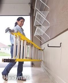 a woman is carrying some equipment in her hand while walking up the stairs to an open garage door