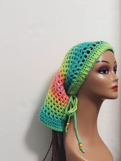 a mannequin head wearing a multicolored crochet hat