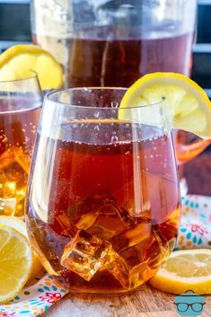 two glasses filled with tea and lemon slices