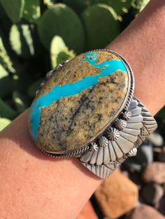 Sterling silver and turquoise. Gorgeous silverwork. Intricate hand-stamped detail. 2 1/2" wide at widest point. Cuff is 1 5/8" wide. Cuff measure 5 3/4" with a 1 1/4" gap. Stamped sterling and signed by Navajo artist. Turquoise Stamped Cuff Bracelet Collectible, Southwestern Engraved Blue Cuff Bracelet, Untreated Turquoise Artisan Cuff Bracelet, Artisan Blue Engraved Cuff Bracelet, Wide Cuff, Hand Stamped, Gap, Ribbon, Cuff