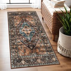 an area rug in the middle of a room with a chair and potted plant