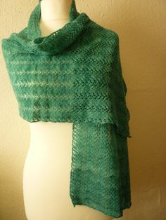 Soft and cosy jade green woollen scarf, hand dyed with natural variations, hand spun and hand knitted from British grown Polwarth wool. The pattern is the traditional Shetland vine lace, very delicate and pretty. Fabric is light and beautifully warm. 152 cms (60 inches) long by 43 cms (17 inches) wide. Gentle hand wash and dry flat. Handmade Mohair Shawl Scarf, Green Knitted Scarf One Size, Green Knitted One-size Scarves, Green Hand Knitted Shawl For Winter, Handmade Alpaca Shawl Scarf, Traditional Handmade Green Shawl, Handmade Green Shawl For Winter, Bohemian Green Knitted Knitting Pattern, Bohemian Green Knitting Pattern