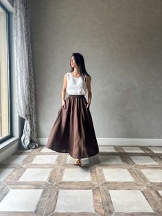 This linen maxi skirt with elastic waist is the perfect addition to any wardrobe. Crafted from high-quality linen, this long skirt is both comfortable and durable, ensuring that it will be a staple in your wardrobe for years to come. Featuring an elastic waist and two side functional pockets, the ABIGAIL linen skirt is designed for maximum comfort and ease of wear. The elastic band allows for a customizable fit, making it perfect for all body types. And with its long length, this linen skirt pro Beach Pleated Long Maxi Skirt, Beach Long Pleated Maxi Skirt, Bohemian Flared Maxi Skirt With Elastic Waistband, Bohemian Bottoms With Elastic Waistband And Voluminous Skirt, Brown Flowy Pleated Maxi Skirt, Bohemian Full Voluminous Skirt, Voluminous Bohemian Maxi Skirt, Brown Full Gathered Skirt, Brown Full Skirt With Gathered Detail