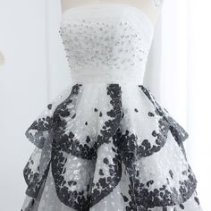 a white and black dress on a mannequin headdress with sequins