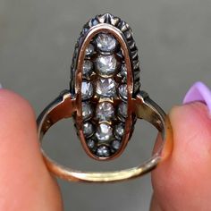 An original Victorian era navette ring set with a cluster of old mine cut diamonds. The diamonds have a total approximate weight of 3.50 carats, I-J color and SI1 clarity overall. The elongated mounting is silver on 18k yellow gold, and bears French import marks. This ring is antique and was handcrafted circa 1870.
The measurements of this ring are approximately 1.00 inch x 0.40 inch. An original Victorian ring this elongated is rare.
This ring can be resized to any finger size at no extra cost. Antique Cluster Ring With Rose Cut Diamonds, Marquise Diamond White Ring With 17 Jewels, Victorian Style Diamond Ring With Diamond Cut, Victorian Oval Diamond Ring With Rose Cut Diamonds, Victorian Diamond White Ring With 17 Jewels, Antique Cluster Diamond Ring With Accents, Antique Cluster Diamond Ring With Diamond Cut, Antique Cluster Diamond Cut Diamond Ring, Antique Cluster Ring With Diamond Accents