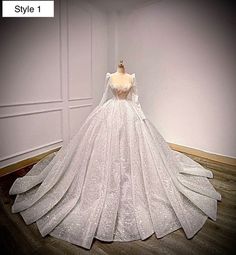 a white wedding dress on display in a room