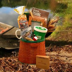 a basket filled with food sitting next to a boat on the water and some other items