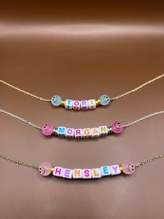 two necklaces that say happy, morgan and smiley on the same beaded chain