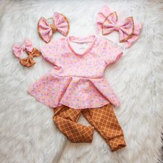 This Beautiful sprinkle Fabric paired with Waffle Cone is so adorable, you will not be able to keep your eyes off your Sweetie.  Your little Sweetheart will be the star of the show when they are rocking this Ice Cream themed set. Choose from adorable baby Peplum Top, Waffle cone pants/leggings, Bow on Nylon, Bow Headband, or All three.  Liverpool fabric ensures longevity of the fit while being breathable. Stylish enough to wear for photo shoot, a visit with family or just around the house.   How Playful Ruffled Sets For Playtime, Cute Ruffled Sets For Playtime, Cute Ruffled Sets For Playdate, Sweet Pink Sets With Ruffles, Pink Playtime Sets With Ruffles, Cute Ruffled Sets For First Birthday, Cute Pink Ruffled Sets, Cute Pink First Birthday Sets, Sweet Spring Sets For First Birthday