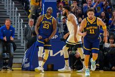 the basketball players are walking on the court