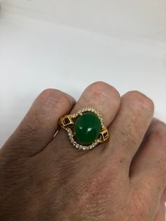 Vintage Lucky Green Nephrite Jade Golden ring Large green nephrite jade Gold finished German Silver Vintage ring, does not tarnish, NOT sterling Size 7, 8, or 9 All rings are shipped free in the US in a nice gift box. Check out our over a THOUSAND great reviews Engraving is $4 per letter and is not always perfect depending on the piece. It can take a few days if the jeweler is busy. This is payable to Paypal Judithsltd@gmail.com Green Cabochon Emerald Ring For Anniversary, Green Emerald Cabochon Ring For Anniversary, Green Cabochon Ring For Anniversary, Collectible Green Emerald Rings, Green Oval Cabochon Emerald Ring Collectible, Green Oval Cabochon Ring For Anniversary, Collectible Jade Gemstone Rings, Collectible Round Green Emerald Ring, Green Cabochon Gemstones For Anniversary