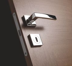 a close up of a door handle on a wooden door