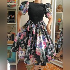 Vintage Puff Sleeve Velvet Florals Dress Pre-Loved Adorable 80s Midi Puff Sleeves Dress With Jewel Neckline Black Velvet Top Area And Very Beautiful Florals Print On Sleeves And Bottom + Bow Tie Back. Zipper Back Closure, Tulle Under Skirt. Label Daysi Kingdom Made In Philippines Size 12 ( Run Small Pls See Measurements) Perfect Condition Shows Small On Top Of Model Modern Size M 28waist 5ft2 (Unzipped For Photos) Measurements Approximately Laid Flat Shoulder To Shoulder 11 1/2" Pit To Pit 15 1/2" Sleeve Length 10" Waist 14" Length 42" This Is A Pre-Owned/Vintage Item. Please Be Sure To Review Pictures And Following The Measurements Details For Best Fit (Vintage Clothing Vintage Black Puff Sleeve Dress, Vintage Fitted Puff Sleeve Dress For Spring, Fitted Vintage Puff Sleeve Dress For Spring, Spring Retro Puff Sleeve Dress, Puff Sleeves Dress, Black Velvet Top, Under Skirt, Velvet Top, Jewel Neckline