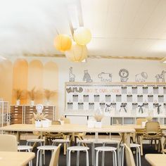 an empty classroom with desks and chairs in front of a whiteboard on the wall