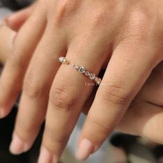 a woman's hand with a diamond ring on it