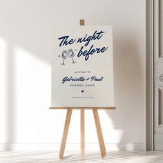 an easel stands in front of a white wall with a sign that reads the night before