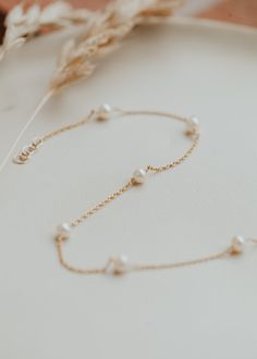 We are head over ankles for pearls! This cable pearl anklet is adorned with the most preciously placed pearls making for a dreamy ethereal feel. A summer must-have. Choose from two sizes: 8.5"-9" and 9.5"-10". Available in 14kt Gold Fill + Sterling Silver. Shown with our Stella Anklet. Handmade in Eau Claire, WI. Our jewelry is handmade so each piece will be unique and may vary slightly from what is pictured. Elegant Pearl Chain Anklets For Wedding, Elegant Pearl Anklets For Wedding, Elegant Wedding Anklets With Pearl Chain, Elegant Wedding Pearl Chain Anklets, Elegant Adjustable Anklets With Pearl Charm, Elegant Adjustable Pearl Anklets, Elegant Pearl Anklets With Pearl Chain, Elegant Pearl Chain Anklets, Elegant Pearl Anklets As Gift