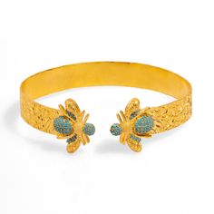 The Mystic Design Gold & Turquoise Honey Bee Cuff Bracelet is a unique statement piece, featuring a 24k gold-plated cuff adorned with two stunning turquoise stones.  The two honey bees on either side add a spiritual and chic element to the design, perfect for those who appreciate both elegance and symbolism. This bracelet is an ideal choice for anyone seeking a stylish, one-of-a-kind accessory that blends mysticism with modern fashion. Details Crafted with high-quality brass and plated with 24k Mystic Design, September Birthstone Jewelry, The Mystic, Gold Bracelet Cuff, Honey Bees, Zodiac Jewelry, Jewelry Ring Box, Turquoise Stones, Men's Jewelry Rings