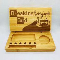 a wooden box with an image of a man in glasses and the words breaking bud on it