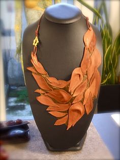 Leather Bib Necklace with flowers and leaves made from high quality soft Italian leather. Each necklace is unique and never repeated. The leaves and flowers weave together as they do in nature under the influence of the wind, the sun, the mood. Made by hand in my cozy little atelier 💖 Volumetric flowers, unique curls of leaves...the work is done without templates, directly on the leather. Every smallest detail is cut, glued and sewn. The work is very subtle and painstaking. The slightest awkward movement and a hole is created on the thinnest of linings! When everything is ready, another layer of organza is put on the bottom and trimmed around the edge. Many hours of work ⭐️ A very large number of different shades of leather have gathered in my atelier over 30 years of work. Think of your Luxury Brown Leather Necklace, Fantasy Necklace, Leather Jewellery, Bold Necklace, Leather Art, Leather Floral, Bib Necklaces, Leather Flowers, Leather Projects