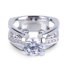 a white gold ring with diamonds on the sides and a center stone in the middle