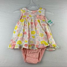 Nwt. Size 18m. Carter’s Floral Bodysuit Dress. This Outfit Is Made As A Sleeveless Bodysuit With A Dress Sewn To The Front And The Back Part Of The Dress Open. It Has A Snap Closure At The Bottom. The Back Has A Button At The Top And The Rest Is Open And Frilly. The Bodysuit Is A Very Light Pink With White Polka Dots. The Dress Part Is White With Light Pink And Yellow Flowers All Over. Made Out Of 100% Cotton. Multicolor Sleeveless Bubble Romper For Spring, Spring Sleeveless Bubble Romper For Playwear, Sleeveless Yellow Cotton Bubble Romper, Yellow Cotton Bubble Romper For Summer, Summer Yellow Cotton Bubble Romper, Yellow Cotton Summer Bubble Romper, Yellow Cotton Bubble Romper For Spring, Multicolor Fitted Cotton Bubble Romper, Fitted Multicolor Cotton Bubble Romper