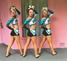 three women in matching outfits posing for the camera