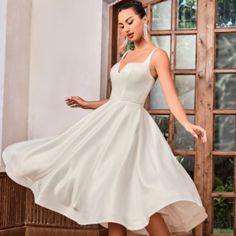 a woman in a white dress is dancing