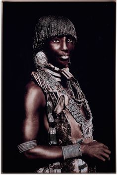 an african woman with jewelry on her neck and chest, standing in front of a black background